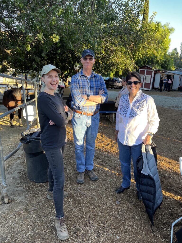 Three people standing and looking at the camera